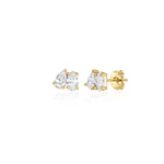 A pair of yellow gold toi et moi style stud earrings with pear and oval diamonds. The earrings are on a white background. the stones are set tilted towards each other and are prong set. 