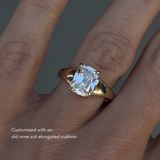 Chunky engagement ring that tapers from the center stone to the back of the ring. The ring is on the hand. The center stone is an old mine cut elongated cushion that is 2.5ct. 