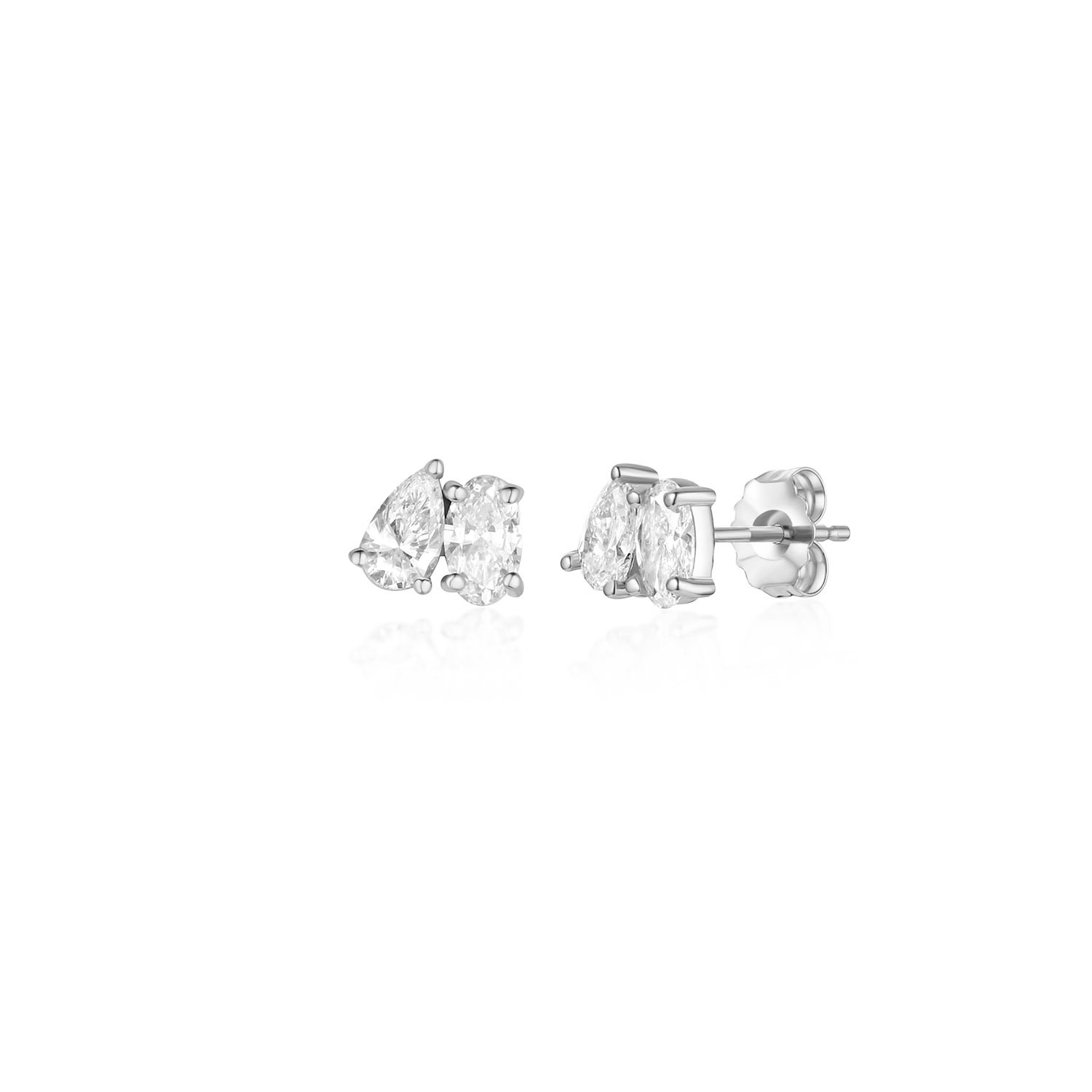 A pair of toi et moi earrings with diamonds set in white gold. The diamonds are pear and oval cut. The earrings are on a white background. the stones are set tilted towards each other and are prong set.