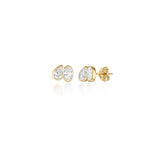A pair of toi et moi style studs with a pear diamond tilted towards an oval diamond. Bezel set in 14k yellow gold.