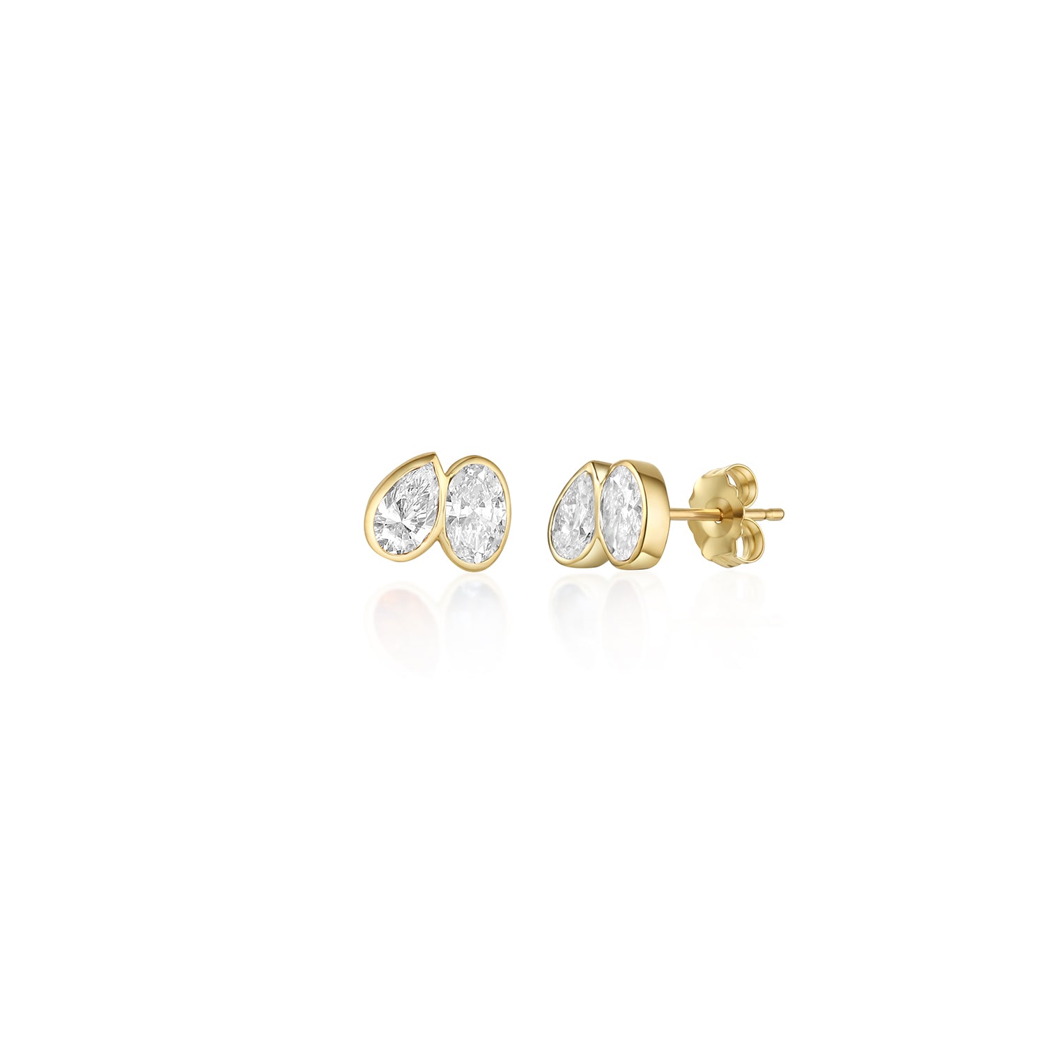 A pair of toi et moi style studs with a pear diamond tilted towards an oval diamond. Bezel set in 14k yellow gold.